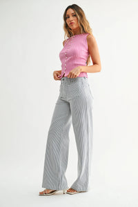 A pink ribbed sleeveless top with button detailing paired with mini patch pocket wide jeans in a casual outfit