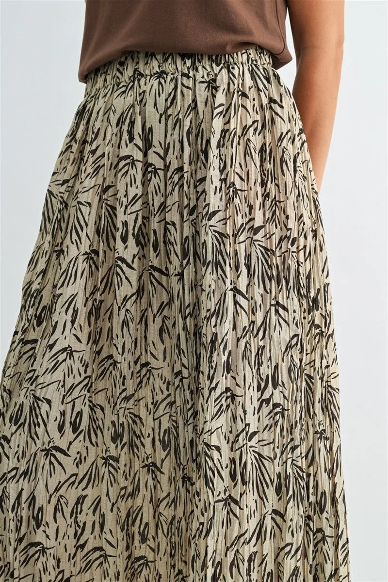 A flowing beige crinkle leaf print midi skirt with black bamboo leaf print and pleated design