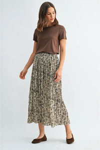 A flowing beige crinkle leaf print midi skirt with pleated design and black leafy patterns