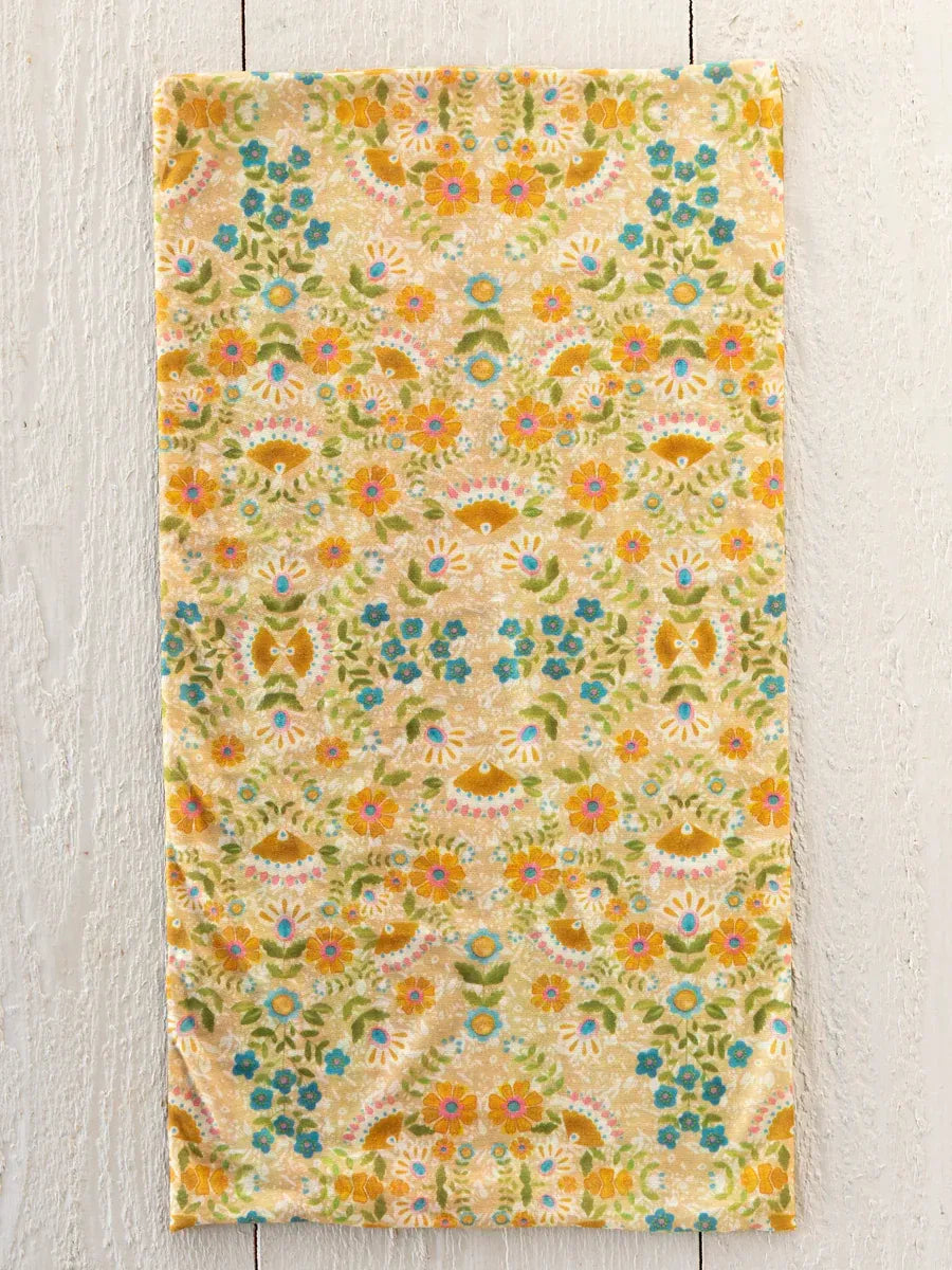 A boho bandeau headband with taupe mandala design featuring a soft textured towel floral pattern in yellow blue and green