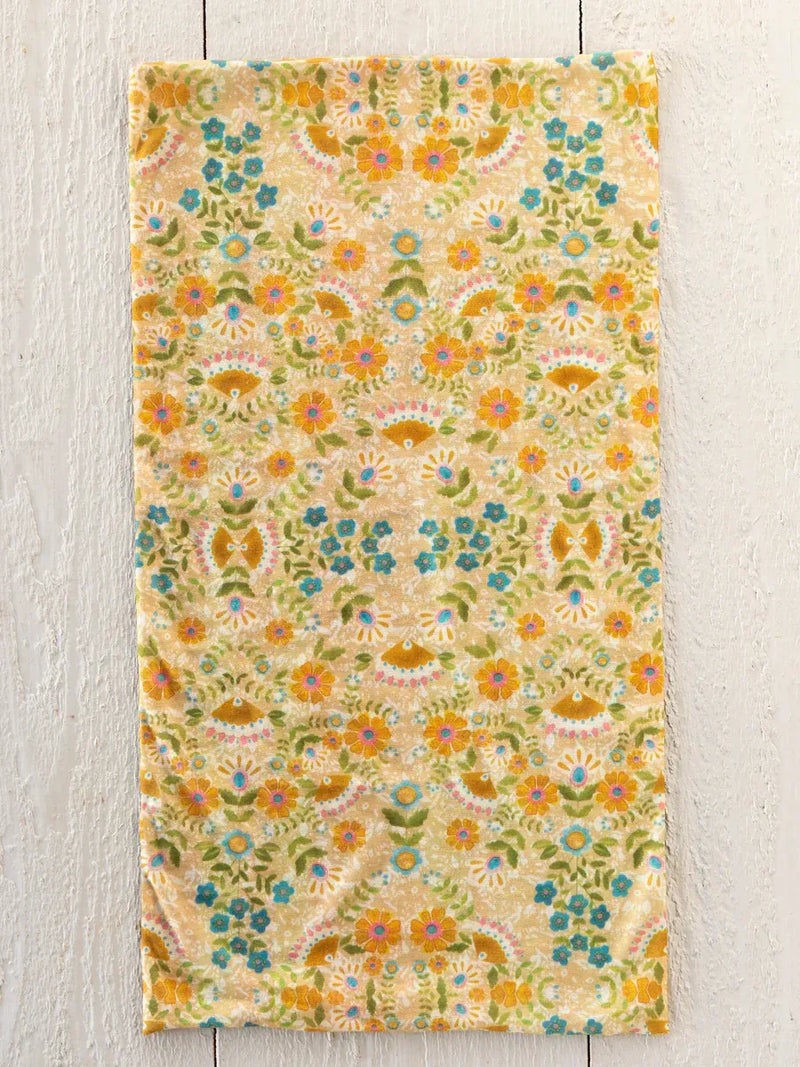 A boho bandeau headband with taupe mandala design featuring a soft textured towel floral pattern in yellow blue and green