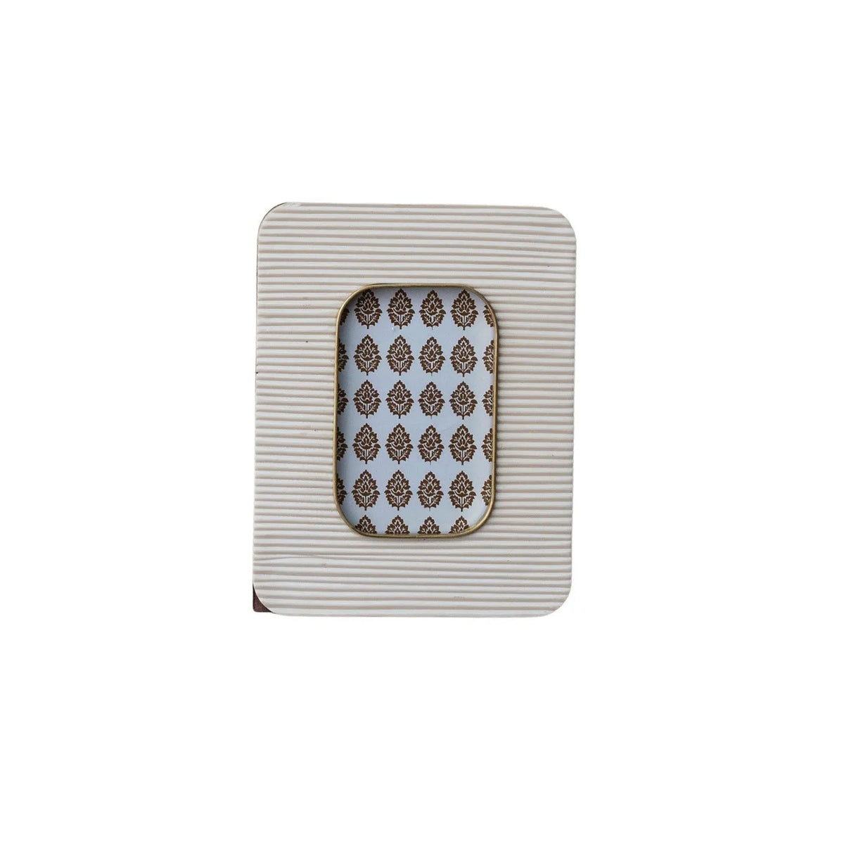 A rectangular white resin ribbed photo frame with brass inlay and an ornate brown damask patterned backing