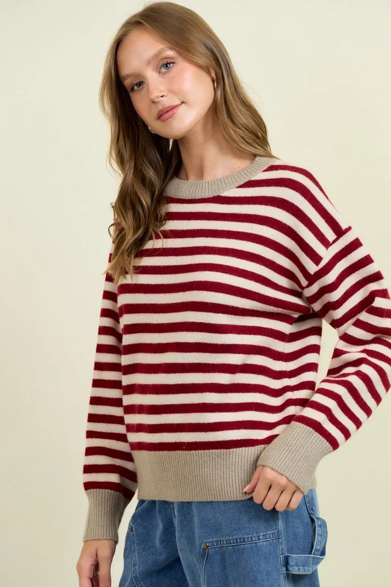 Round neck stripe color block sweater in red and cream knit with beige ribbed cuffs neckline and hem
