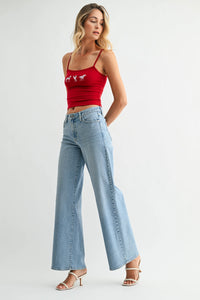 Red cropped tank with white horse embroidery, high-rise wide-leg denim jeans