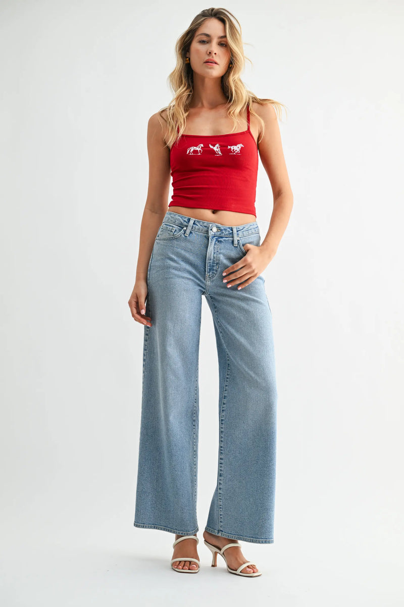 Red cropped tank with white horse embroidery on high-rise wide-leg denim jeans