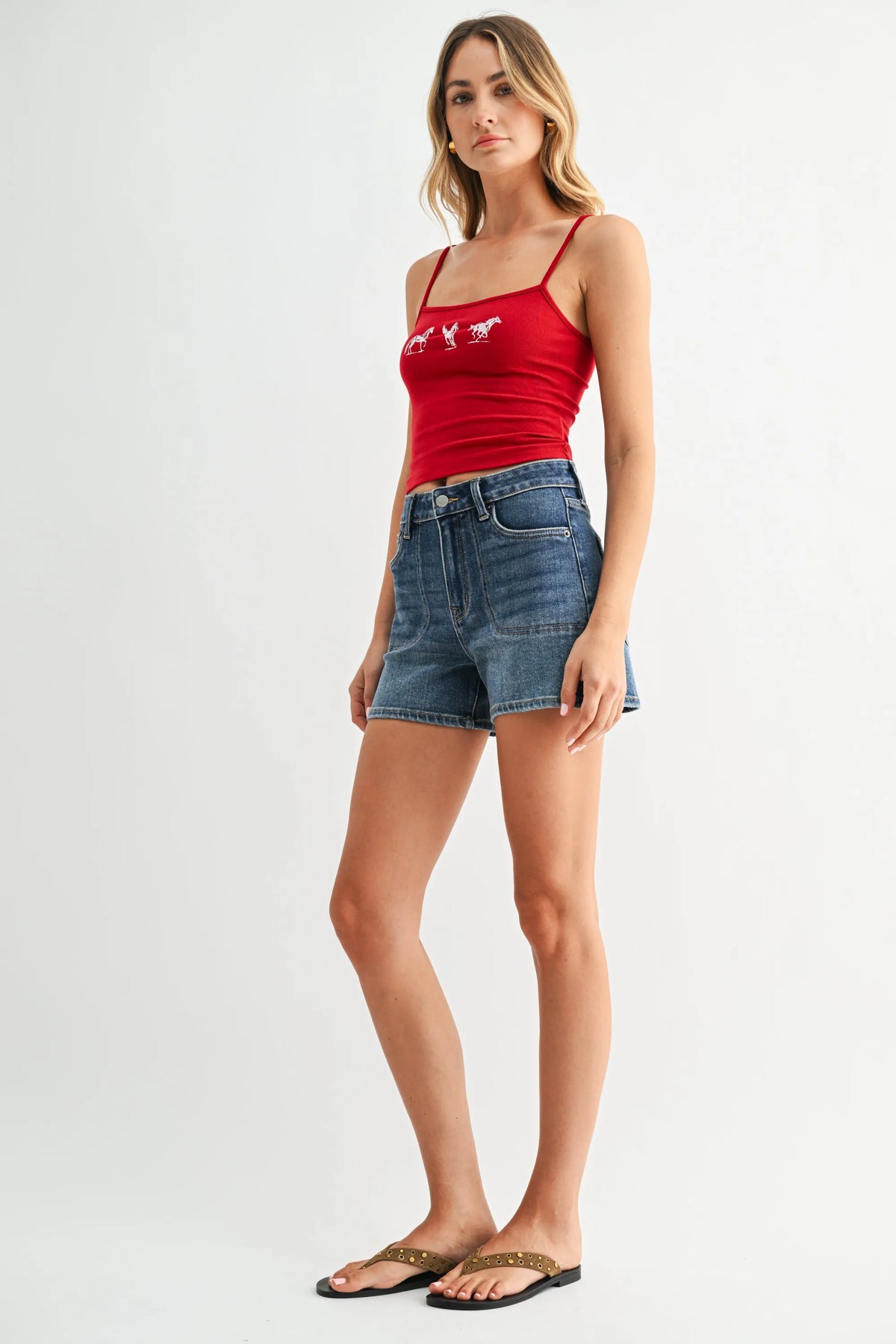 Red cropped tank with white horse embroidery on mid rise western pocket denim short