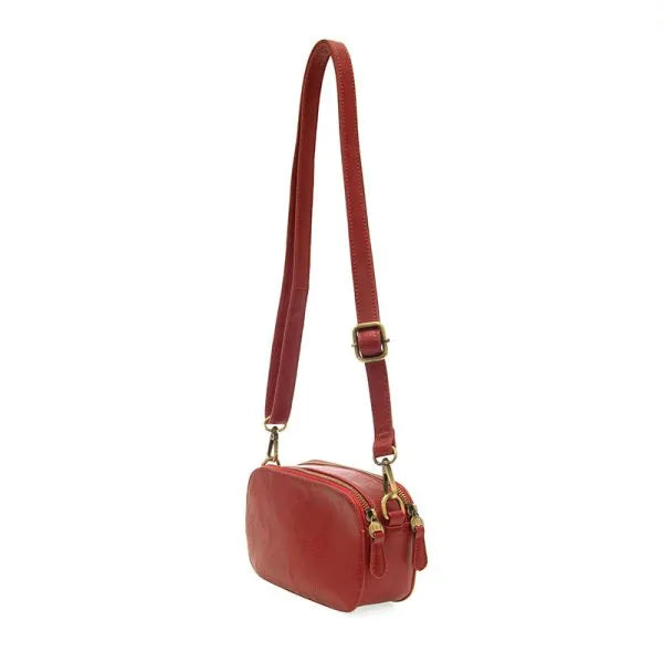 Red leather layne double zip mini camera crossbody bag with gold-tone hardware and dual zippers for secure storage