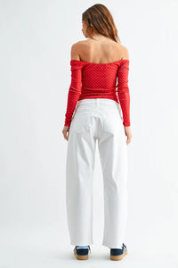 Red off-the-shoulder long-sleeved top with white polka dots paired with med rise stretch twill comfort barrel jeans denim