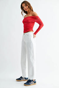 Red polka dot long sleeve off the shoulder crop top paired with med rise stretch twill comfort barrel jeans denim
