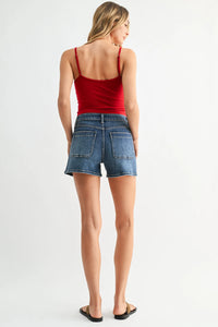 Mid rise western pocket denim shorts with red spaghetti strap top