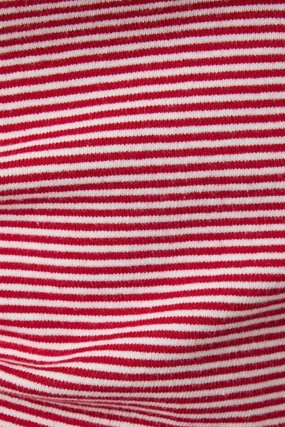 Close-up of red and white knit fabric of contrasted striped tank top featuring horizontal stripes in soft material