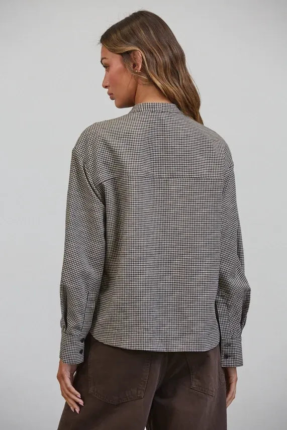 A relaxed-fit long-sleeved tied collar shirt in black and white plaid bow tied houndstooth pattern