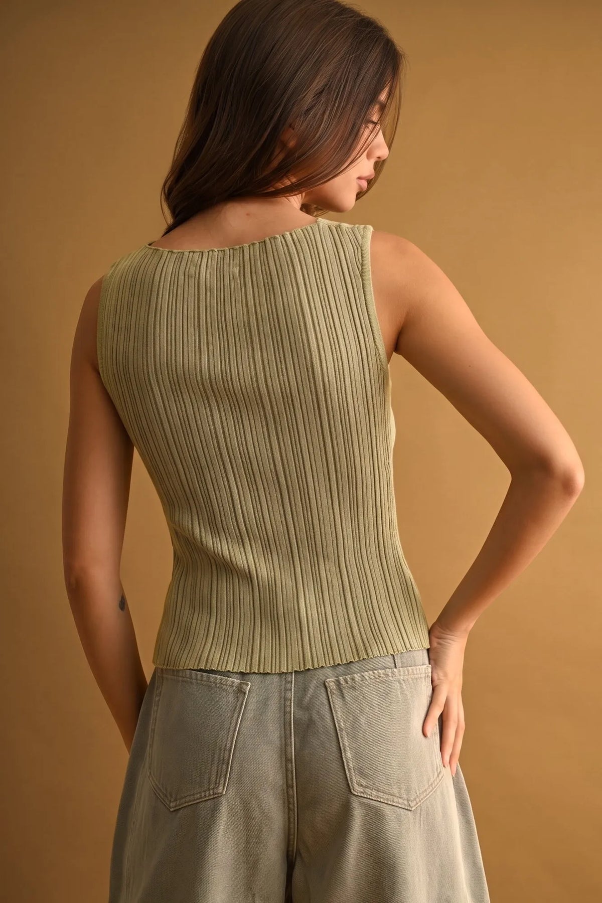 Ribbed knitted top in olive green viscose with sleeveless design rounded neckline and slightly flared hem for boho chic style