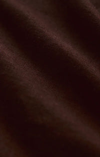 Rich burgundy silk fabric with smooth lustrous texture and subtle sheen featured in alfie linen button up shirt