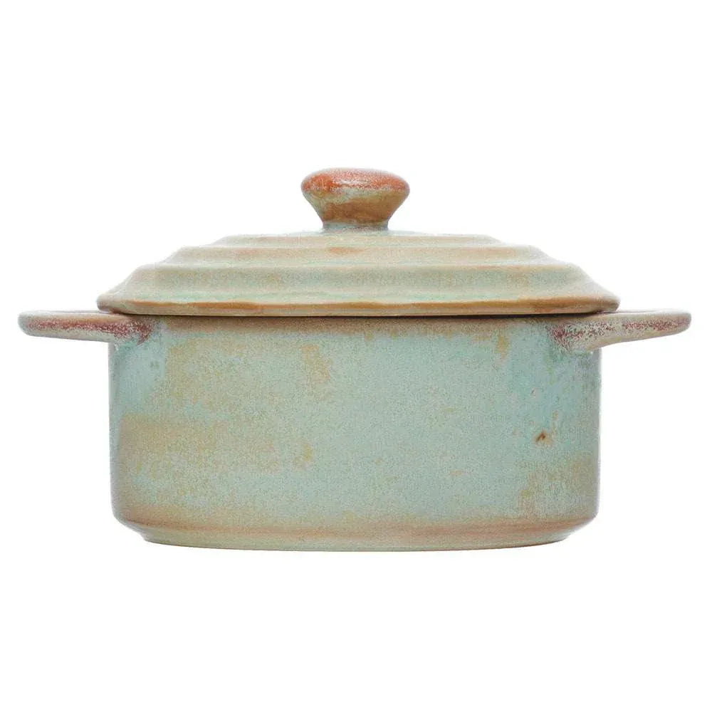 A rustic stoneware mini matte celadon color baker with sage green glaze, brown accents, two handles, and matching lid