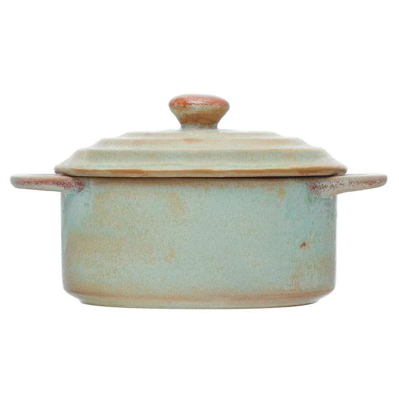 A rustic stoneware mini matte celadon color baker with sage green glaze, brown accents, two handles, and matching lid