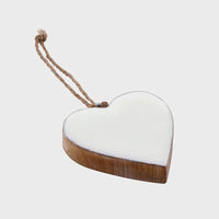 A rustic enamel wood heart ornament with white enamel finish and natural wood grain suspended by a jute cord