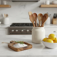 Hand-carved mango wood serving board with rustic salt dish and rosemary
