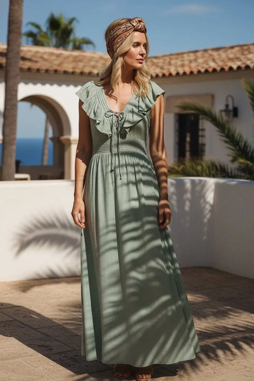 A flowing sage green midi dress with V neck, lace-up neckline, side slit, and ruffled slit flutter sleeves