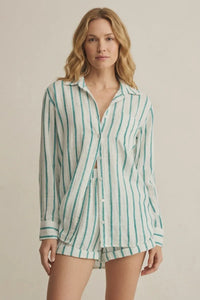 A woman wears a loose saturdays stripe button long-sleeved shirt with vertical green and white stripes