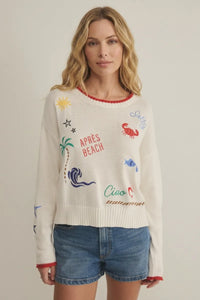 White knit day sienna sweater with colorful embroidered beach designs and red trim on neckline and cuffs