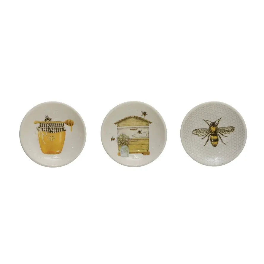 Set of three white ceramic coasters with honey inspired bee illustrations for shop daisy womens boho chic clothing