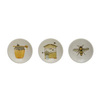 Set of three white ceramic coasters with honey inspired bee illustrations for shop daisy womens boho chic clothing
