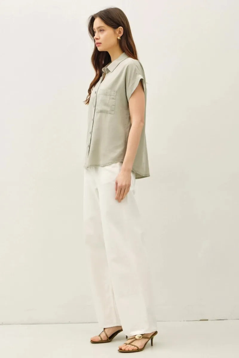 A light sage green short dolman sleeve button shirt with subtle texture and a single chest pocket