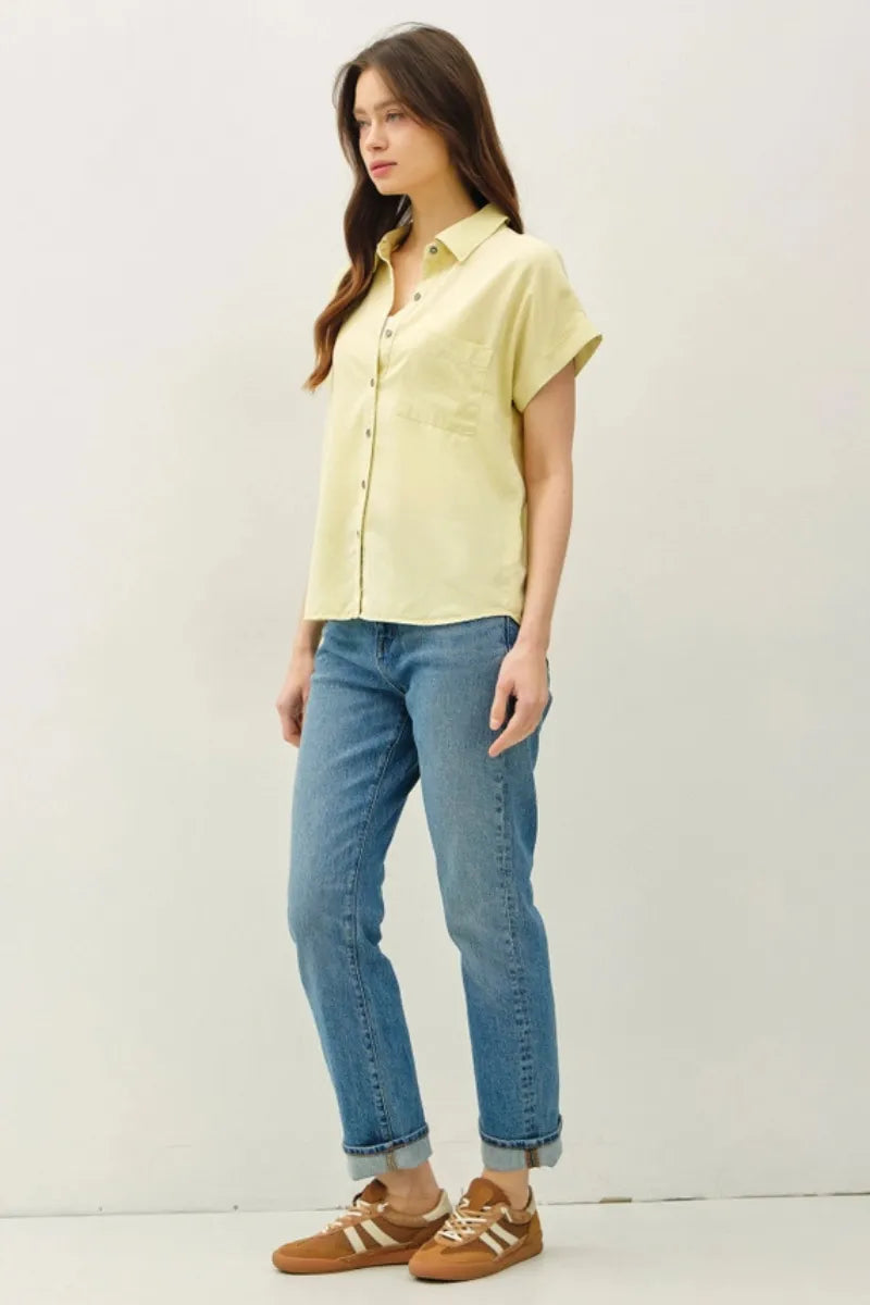 A pale yellow short dolman sleeve button shirt with classic collar and front pocket for casual wear