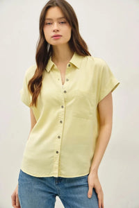 A pale yellow short dolman sleeve button shirt with a classic collar and front buttons for casual wear