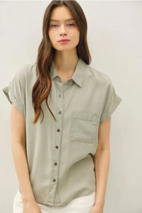 A soft sage green short dolman sleeve button shirt with relaxed fit and single chest pocket