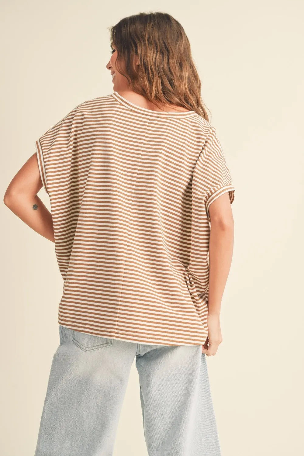 A loose-fitting striped pattern short sleeve top in beige and cream with horizontal stripes for casual wear