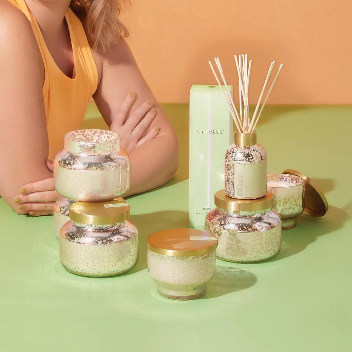 Mercury iridescent candle glass diffuser with silver and gold speckled metallic finish and reed sticks inside