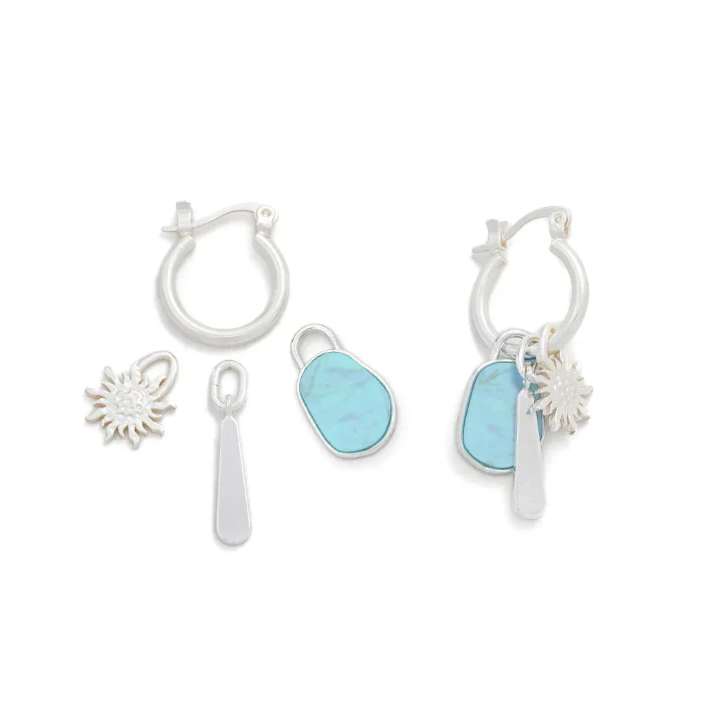 Silver hoop interchangeable charm earrings featuring turquoise sea glass charms and a sun pendant design