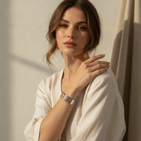 Silver-toned bohemian mixed metal stretch bracelet with rectangular textured center and smooth metallic edges