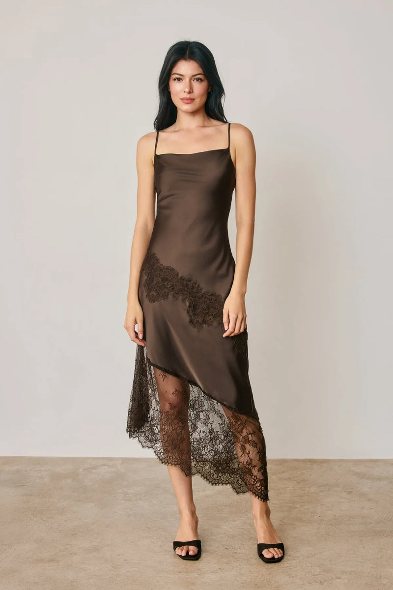 Achocolate brown satin slip dress with asymmetrical black lace trim along the hemline