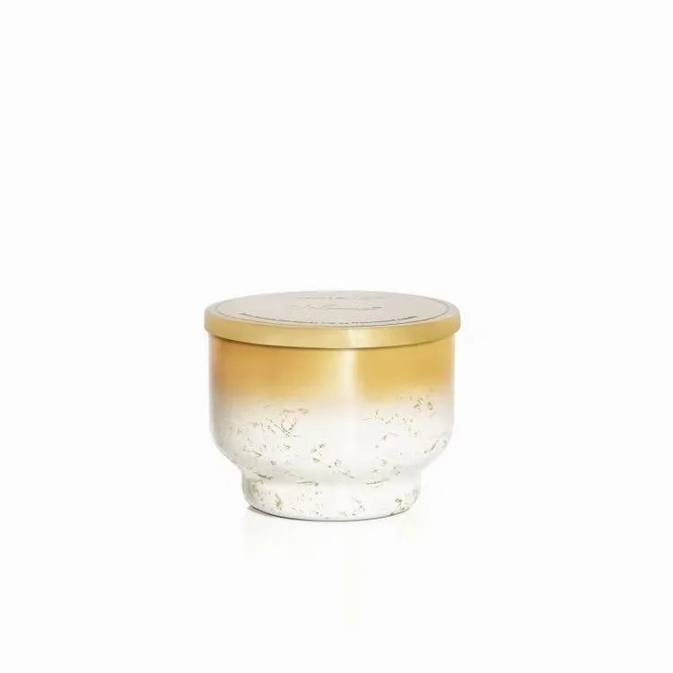 A sleek volcano glimmer inverted candle 10oz with gradient glass jar gold lid and speckled white to gold interior