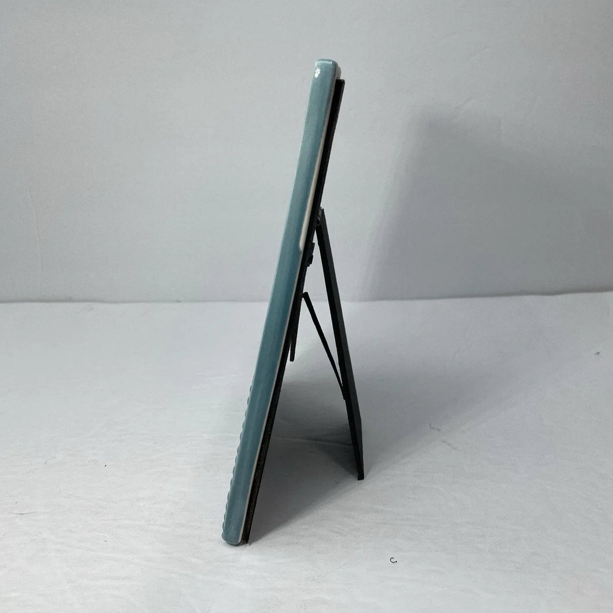 A sleek light blue stoneware heart icon ceramic picture frame with glossy finish and minimalist design