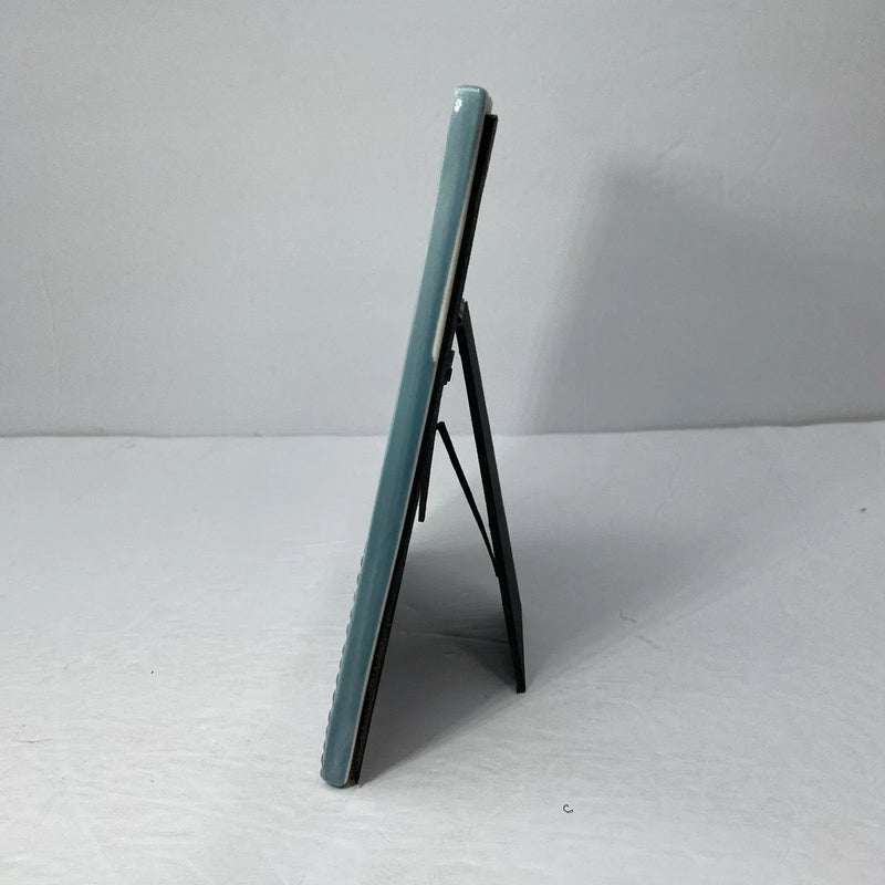 A sleek light blue stoneware heart icon ceramic picture frame with glossy finish and minimalist design