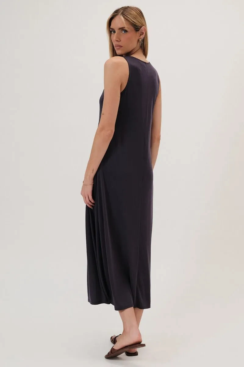 A sleek black sleeveless maxi dress with round neck narrow shoulder and flowing a line silhouette with subtle sheen