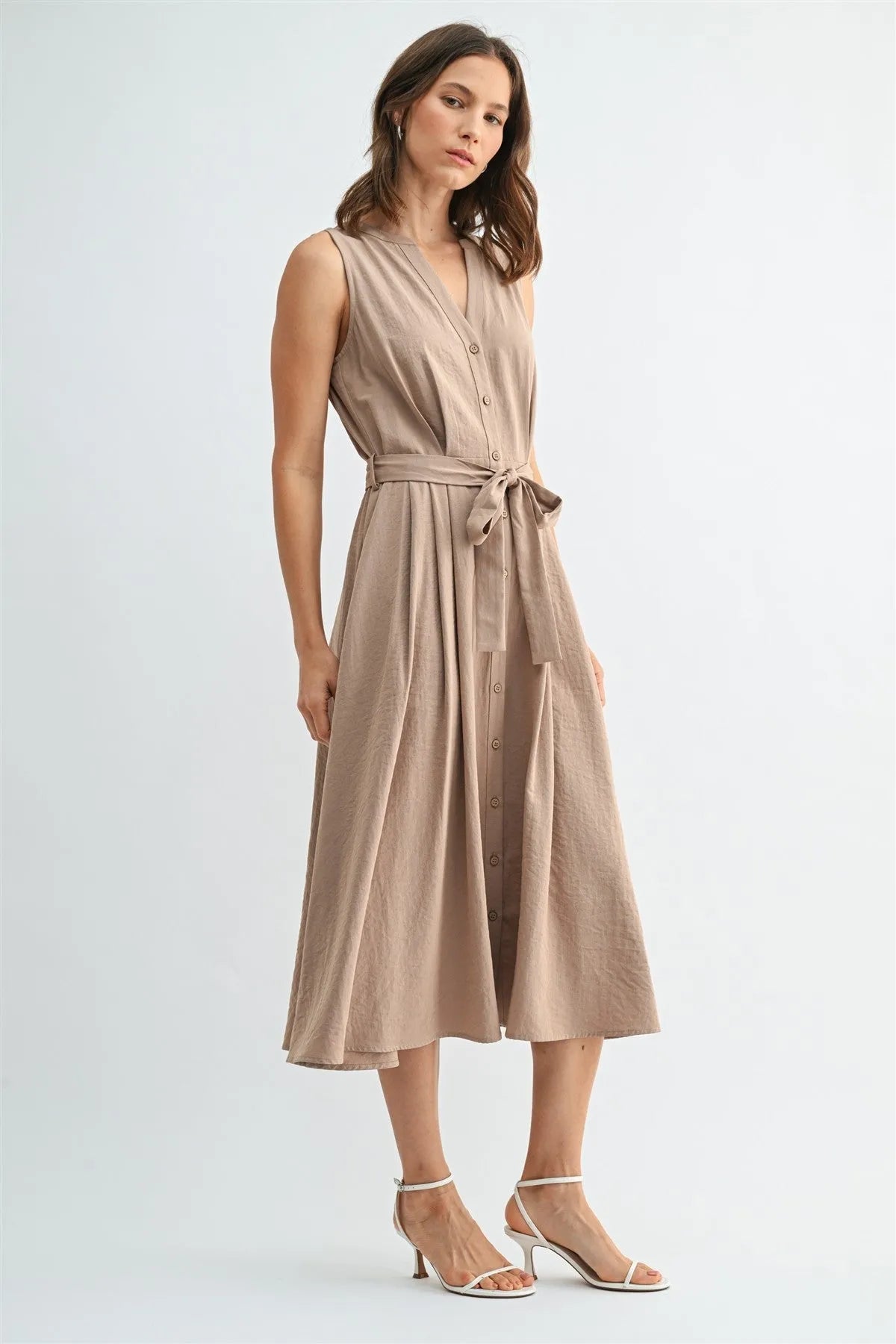 A sleeveless beige button front tie midi dress with v neck and a tied waistband in lightweight fabric