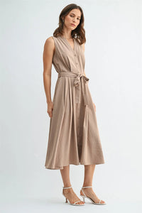 A sleeveless beige button front tie midi dress with v neck and a tied waistband in lightweight fabric