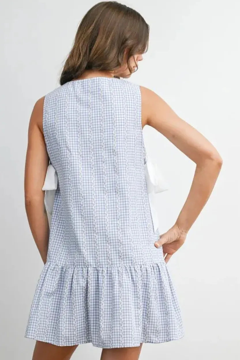 Side tie gingham flounce mini dress in blue and white with sleeveless design and ruffled embroidered hem detail