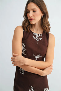 A sleeveless brown embroidery sleeveless midi dress with delicate white floral embroidery perfect for elegant occasions