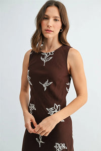 A brown embroidery sleeveless midi dress with delicate white floral embroidery perfect for elegant occasions