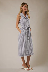 A sleeveless button-down midi dress in light blue and white stripes with a matching waist tie belt at the waist