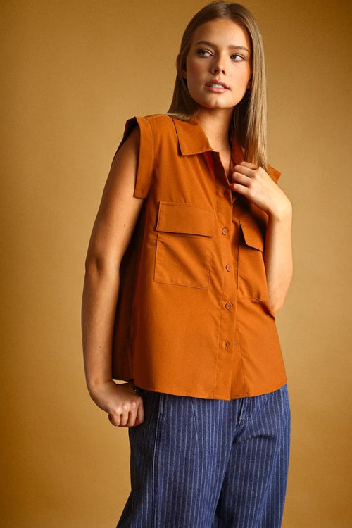 Orange sleeveless chiffon blouse with collar front pockets and button front in lightweight fabric