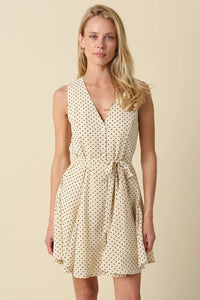 Cream-colored sleeveless mila polka dot button front mini dress with black polka dots and button-front design