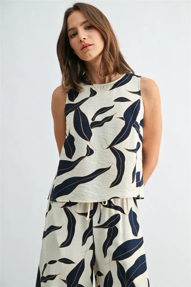 Leaf print button sleeveless top in cream fabric with navy blue leaves and textured finish for women’s boho style