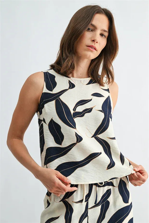 Cream sleeveless top with bold navy leaf print and back button detail women’s boho button sleeveless design